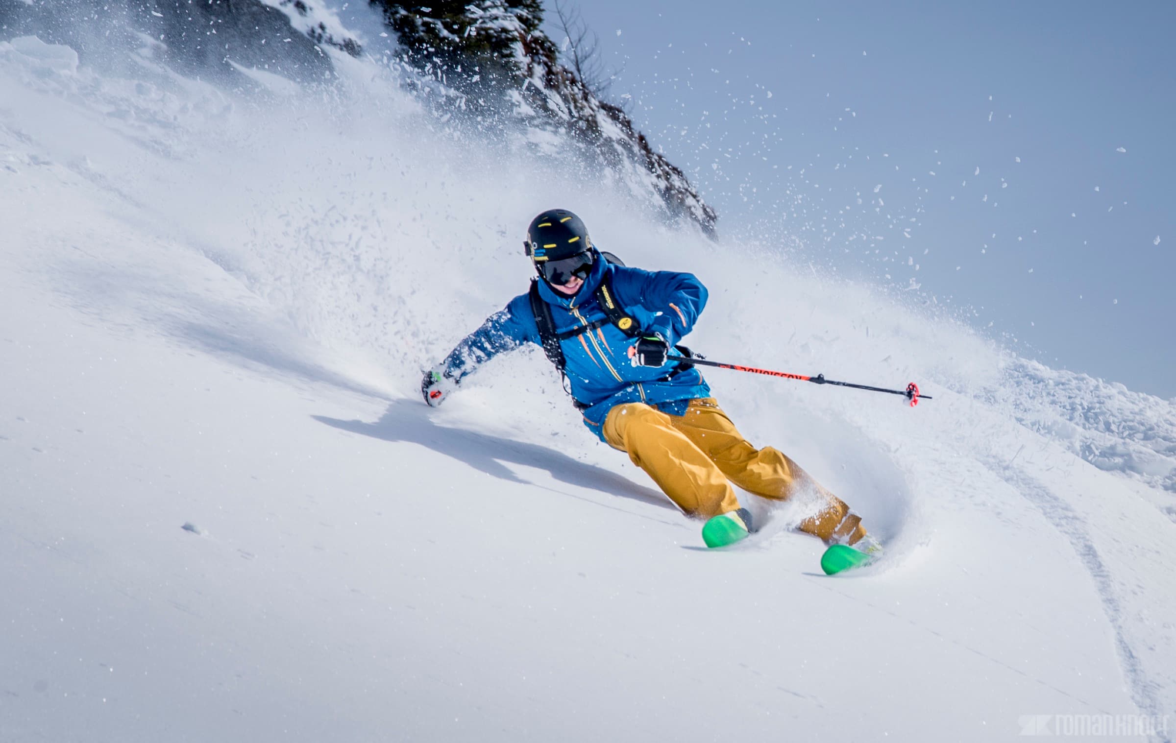 Skier carving through powder in the Wasatch Mountains near The Lifthouse