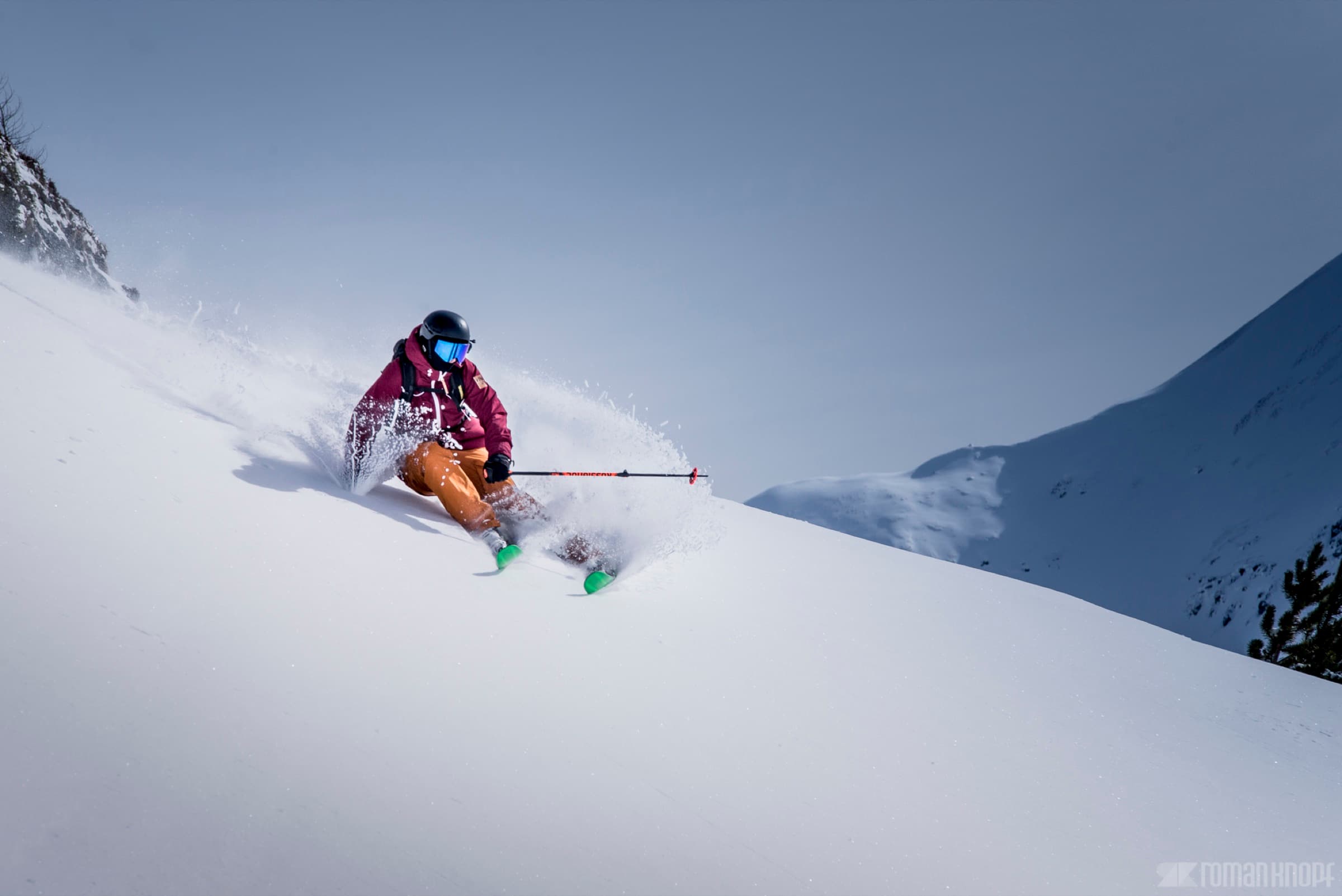 Skier making big powder turns in the Wasatch Mountains near The Lifthouse