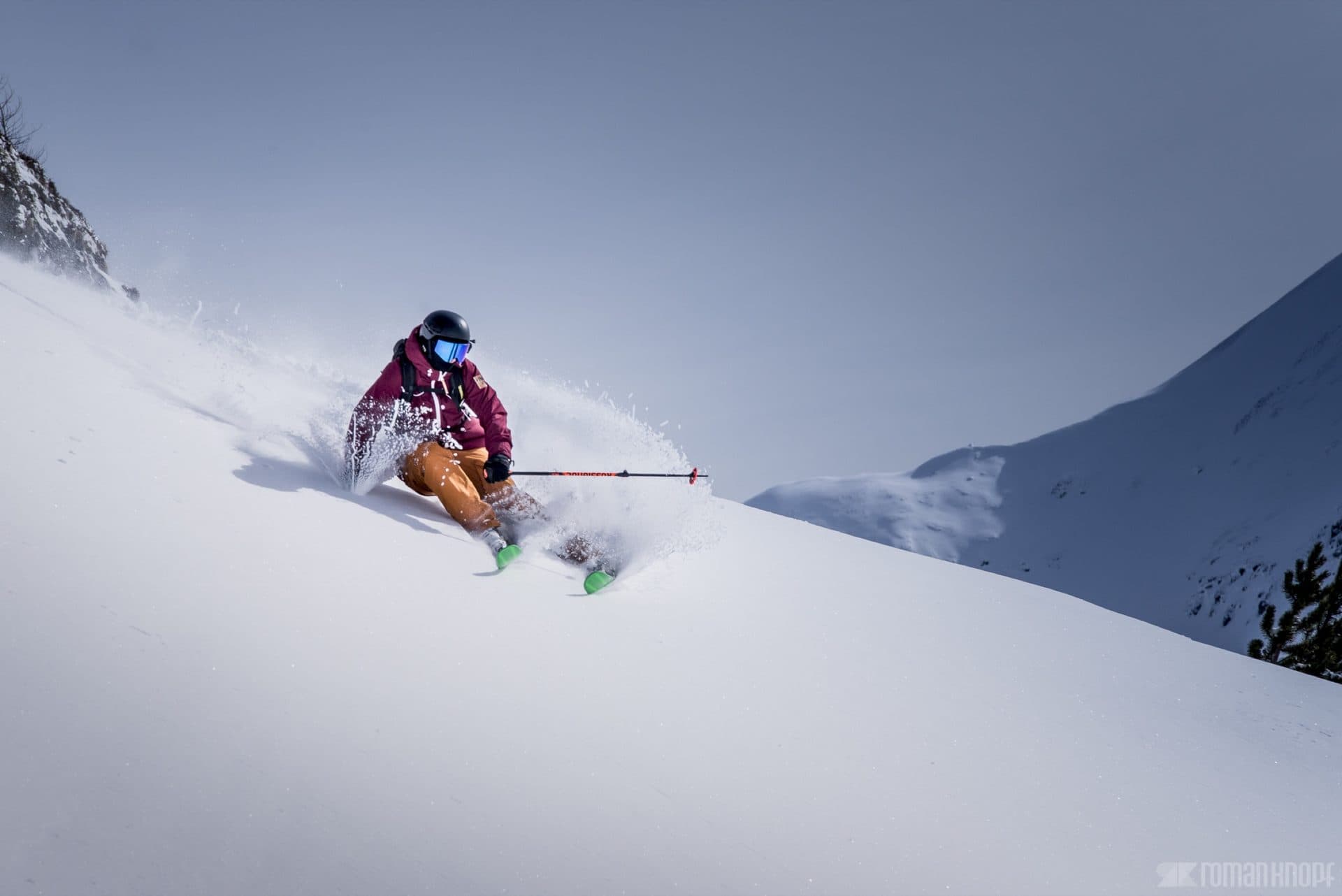Skier carving a powder turn in the Wasatch Mountains near The Lifthouse