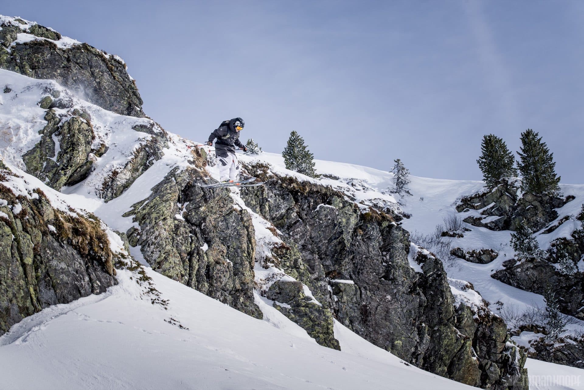 Backcountry skier dropping a cliff in Utah's Wasatch Mountains