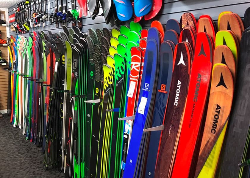 Inside The Lifthouse Ski Shop — ski wall display with Atomic, Rossignol, Salomon and Volkl