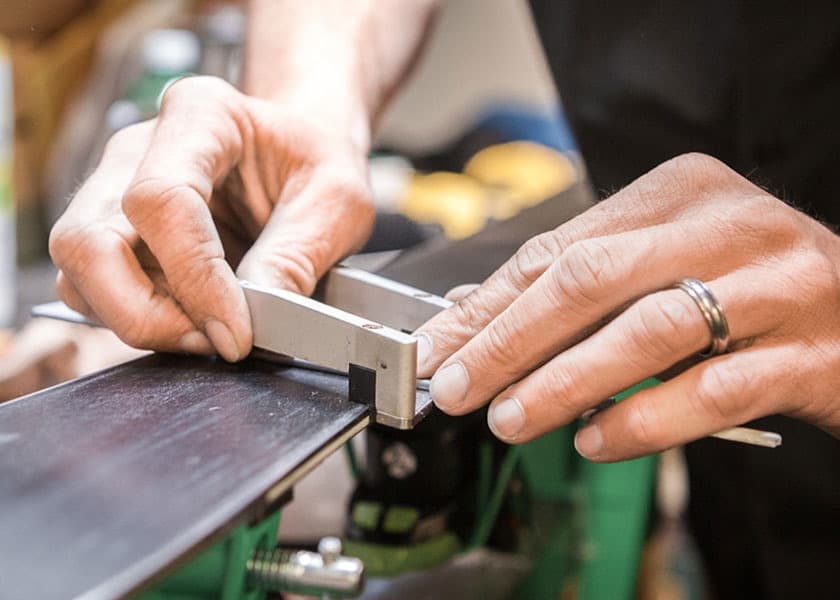 Expert technician tuning ski edges at The Lifthouse in Cottonwood Heights